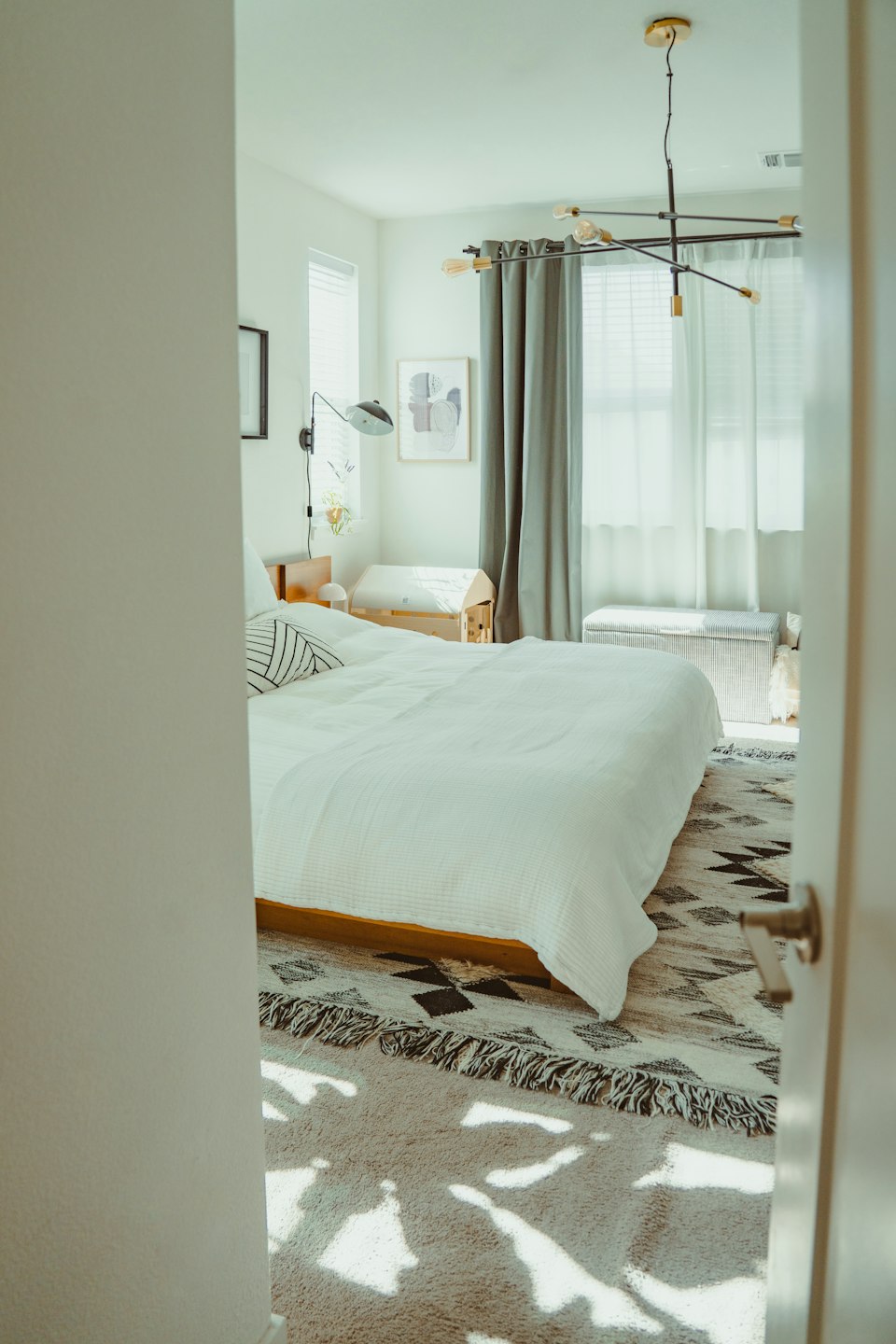 Modern bedroom with a patterned rug over flooring